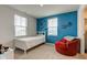 Bedroom with accent wall and cozy red swivel chair at 900 Sunchaser Rd, Lebanon, IN 46052
