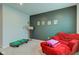 This bedroom features a red lounge chair, gray walls and carpeted floors at 900 Sunchaser Rd, Lebanon, IN 46052