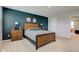 This bedroom features a queen bed with two nightstands and a moody accent wall at 900 Sunchaser Rd, Lebanon, IN 46052