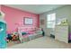 Bright bedroom with a pink accent wall and white furnishings at 900 Sunchaser Rd, Lebanon, IN 46052