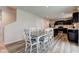 Open dining area featuring a white table, modern lighting, and adjacent kitchen at 900 Sunchaser Rd, Lebanon, IN 46052