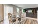 Dining area with a white table, gray sofa in the background, and modern flooring at 900 Sunchaser Rd, Lebanon, IN 46052