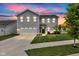 Beautiful two-story home featuring a well-manicured lawn and attached two-car garage, illuminated by a vibrant sunset at 900 Sunchaser Rd, Lebanon, IN 46052