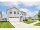 Attractive two-story home showcasing a manicured lawn, spacious driveway, and convenient two-car garage at 900 Sunchaser Rd, Lebanon, IN 46052