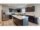 Modern kitchen featuring stainless steel appliances, dark cabinets, and an island with marble countertop at 900 Sunchaser Rd, Lebanon, IN 46052