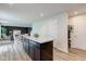Open kitchen view with a marble island, dark cabinets, and access to the dining and living areas at 900 Sunchaser Rd, Lebanon, IN 46052
