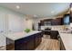 Well-lit kitchen featuring stainless steel appliances, dark cabinetry, and a marble-top island at 900 Sunchaser Rd, Lebanon, IN 46052