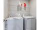 Laundry room featuring a new washer and dryer set with overhead shelving for storage at 900 Sunchaser Rd, Lebanon, IN 46052