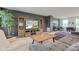 Comfortable living room with a gray sofa, wooden coffee table, and built-in entertainment center at 900 Sunchaser Rd, Lebanon, IN 46052