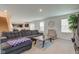 Cozy living room featuring a gray sofa, wooden coffee table, and staircase at 900 Sunchaser Rd, Lebanon, IN 46052
