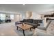 Open living space with a gray sofa, wooden coffee table, and adjacent dining area at 900 Sunchaser Rd, Lebanon, IN 46052