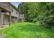 A large backyard with ample lawn space and a building with a balcony in a lush, green setting at 9317 Muir Ln, Fishers, IN 46037