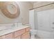 Bathroom features a vanity, toilet, and shower-tub combo with a decorative mirror and curtain at 9317 Muir Ln, Fishers, IN 46037