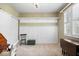 Cozy bedroom with wainscoting, neutral carpet, and custom shelving and storage at 9317 Muir Ln, Fishers, IN 46037