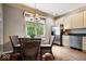 A combined dining area and kitchen features neutral colors, stainless steel appliances and hardwood floors at 9317 Muir Ln, Fishers, IN 46037
