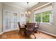 Charming dining area with hardwood floors, French doors, and a window with wicker chairs at 9317 Muir Ln, Fishers, IN 46037