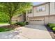 Well-maintained townhome with a lovely landscaped yard, inviting entrance, and attached garage with decorative windows at 9317 Muir Ln, Fishers, IN 46037