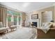 Bright living room with hardwood floors, fireplace, built-in shelving, and French doors to the outside at 9317 Muir Ln, Fishers, IN 46037