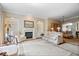 Elegant living room with fireplace, built-in bookshelves, and neutral-toned furniture at 9317 Muir Ln, Fishers, IN 46037