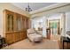 Cozy sitting area featuring wood floors and a large, decorative wooden cabinet at 9317 Muir Ln, Fishers, IN 46037