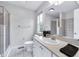 Bright bathroom featuring a window, white cabinetry, a vessel sink, and a tiled shower with glass doors at 952 Junction Pl, Indianapolis, IN 46220