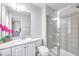 Well-lit bathroom with a white vanity, granite countertop, a vessel sink, and a tiled shower at 952 Junction Pl, Indianapolis, IN 46220