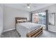 Cozy bedroom with a wood-frame bed, soft grey carpet, and a large window with neighborhood views at 952 Junction Pl, Indianapolis, IN 46220