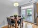 Dining area with hardwood floors, a view of the back deck, and a wooden dining table at 952 Junction Pl, Indianapolis, IN 46220