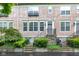 Charming townhouse with inviting stone steps, manicured bushes, and a neutral stucco facade at 952 Junction Pl, Indianapolis, IN 46220
