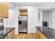 Spacious kitchen featuring stainless steel refrigerator, granite countertops, hardwood floors, and wood cabinets at 952 Junction Pl, Indianapolis, IN 46220
