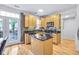 Bright kitchen features wood cabinets, stainless appliances, and a center island, complete with a door leading to the outside at 952 Junction Pl, Indianapolis, IN 46220
