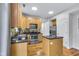 Well-lit kitchen featuring stainless steel appliances, wooden cabinetry, granite countertops, and a central island at 952 Junction Pl, Indianapolis, IN 46220
