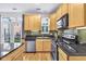 Modern kitchen with stainless steel appliances, wood cabinetry, granite countertops and lots of natural light at 952 Junction Pl, Indianapolis, IN 46220