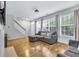 Inviting living area with hardwood floors, lots of natural light, and staircase at 952 Junction Pl, Indianapolis, IN 46220