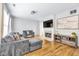 Open-concept living room featuring hardwood floors, cozy seating, fireplace, and entertainment center at 952 Junction Pl, Indianapolis, IN 46220