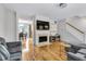 Bright living room featuring fireplace, hardwood floors and open to dining area at 952 Junction Pl, Indianapolis, IN 46220