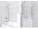 Bright white shower with tiled walls, dual shower heads, a built-in seat, and seamless glass doors at 952 Junction Pl, Indianapolis, IN 46220