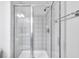 Glass-enclosed shower featuring white tile, a rainfall shower head, and chrome hardware at 952 Junction Pl, Indianapolis, IN 46220