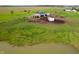 Expansive acreage with charming barn, fenced paddocks, small pond, and lush green pastures offers serene rural living at 9621 N County Road 25 W, Muncie, IN 47303