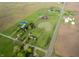 Breathtaking aerial view of a sprawling property featuring a picturesque pond and verdant fields, close to the road at 9621 N County Road 25 W, Muncie, IN 47303