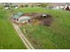 Aerial view of a large barn with several outbuildings surrounded by fields at 9621 N County Road 25 W, Muncie, IN 47303