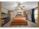 Comfortable main bedroom with a ceiling fan and door to en-suite bathroom at 9621 N County Road 25 W, Muncie, IN 47303