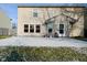 A backyard with a concrete patio visible, dusted with snow, and some outdoor items on the slab at 9955 Orange Blossom Trl, Fishers, IN 46038