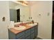 Bathroom with double sinks, grey cabinetry, and a large mirror at 9955 Orange Blossom Trl, Fishers, IN 46038