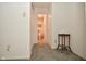 Hallway leading to a bathroom with white walls and carpeted floors at 9955 Orange Blossom Trl, Fishers, IN 46038
