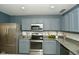 Modern kitchen with stainless steel appliances and gray cabinetry, ready for culinary adventures at 9955 Orange Blossom Trl, Fishers, IN 46038