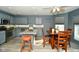 Well-equipped kitchen features a center island, stainless steel appliances, and stylish gray cabinetry at 9955 Orange Blossom Trl, Fishers, IN 46038