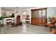 Open-concept living room with modern gray floors, neutral paint, and a mix of vintage and modern furniture at 9955 Orange Blossom Trl, Fishers, IN 46038