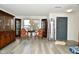 Cozy living room featuring wood-look floors, china cabinets, elegant chairs, natural light, and neutral walls at 9955 Orange Blossom Trl, Fishers, IN 46038