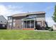 A spacious backyard with a well-maintained lawn, patio furniture, and a screened-in porch at 10267 Ranford Blvd, Fishers, IN 46040